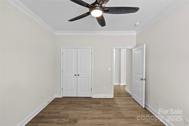 unfurnished bedroom with hardwood / wood-style flooring, ceiling fan, crown molding, and a closet