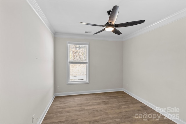 spare room with hardwood / wood-style floors, ceiling fan, and crown molding