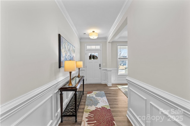 entryway featuring dark wood-type flooring and crown molding