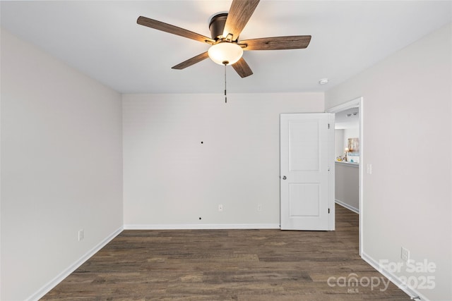 spare room featuring dark hardwood / wood-style flooring and ceiling fan