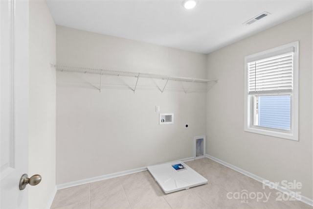 laundry room with electric dryer hookup, light tile patterned floors, and washer hookup