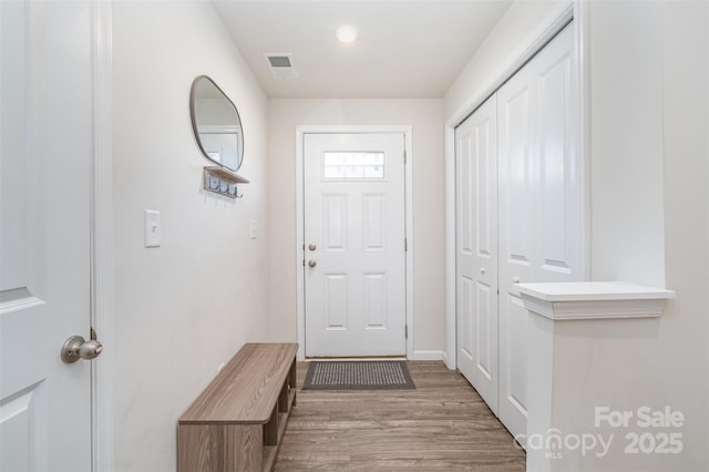 doorway to outside with light wood-type flooring