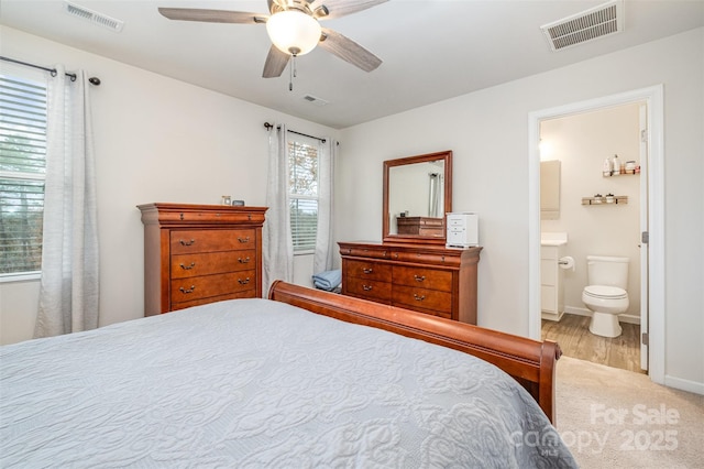 bedroom featuring ceiling fan and ensuite bath