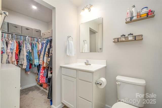 bathroom featuring vanity and toilet