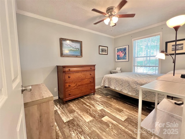 bedroom with ceiling fan, ornamental molding, a textured ceiling, and dark wood-type flooring