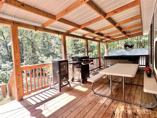 wooden deck featuring a grill