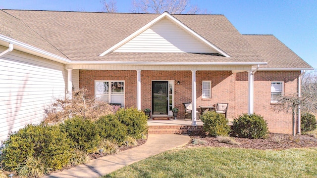 view of front of home with a porch and a front lawn