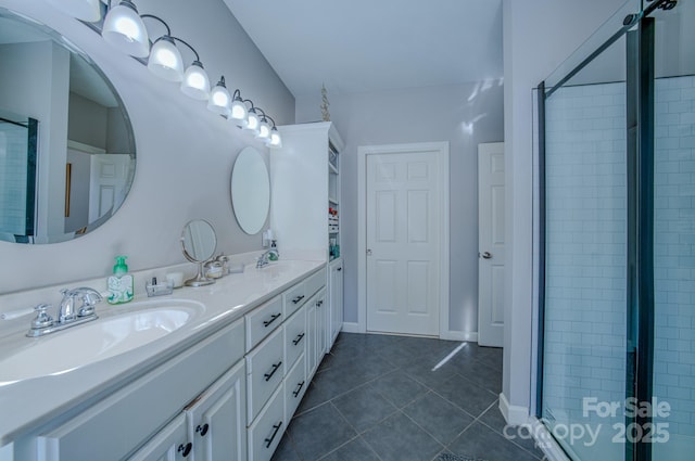 bathroom with a stall shower, tile patterned flooring, a sink, and double vanity