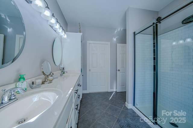 full bathroom featuring double vanity, tile patterned floors, a sink, and a shower stall