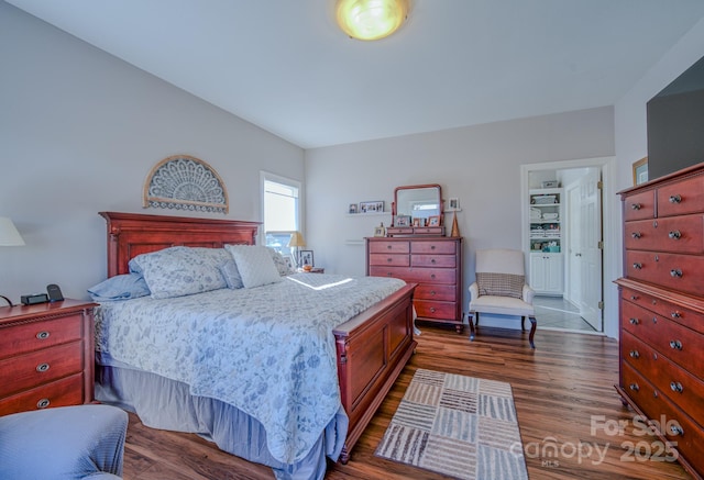 bedroom with dark wood-style flooring