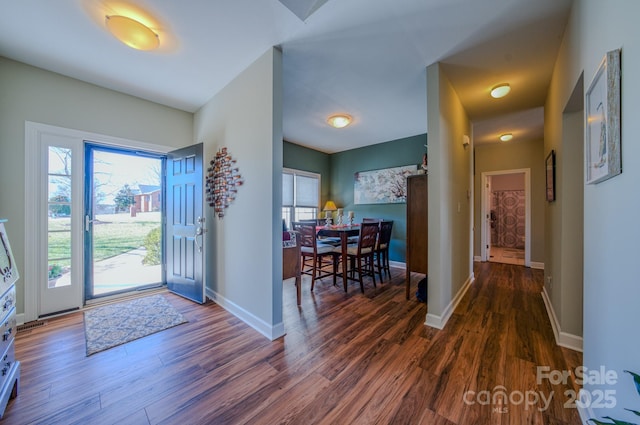 entryway featuring baseboards and wood finished floors