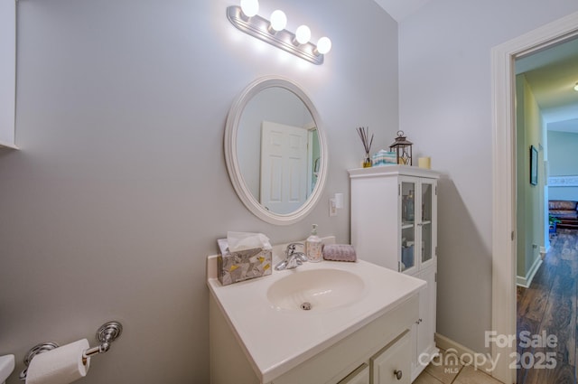 bathroom with vanity and baseboards