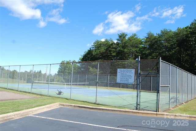 view of sport court with a gate and fence