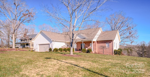 single story home featuring a garage, a front lawn, and brick siding