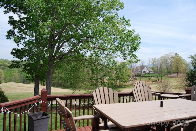 wooden deck featuring outdoor dining space