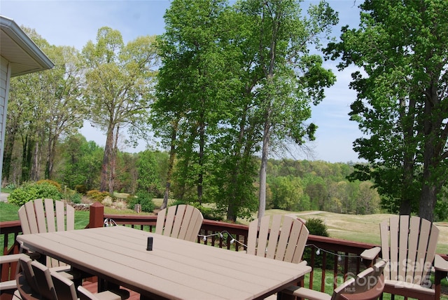 wooden terrace with outdoor dining area