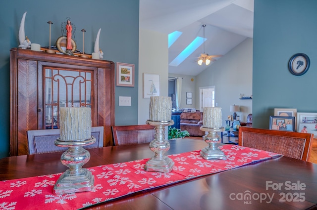 dining room with a ceiling fan and high vaulted ceiling