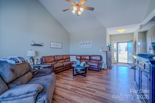 living area featuring wood finished floors, high vaulted ceiling, and ceiling fan