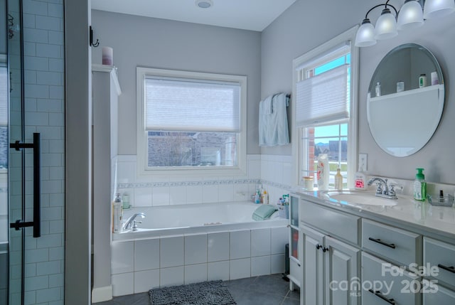 full bath featuring a garden tub, tile patterned floors, vanity, and a stall shower