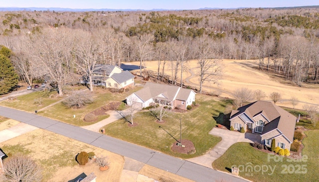 birds eye view of property with a forest view