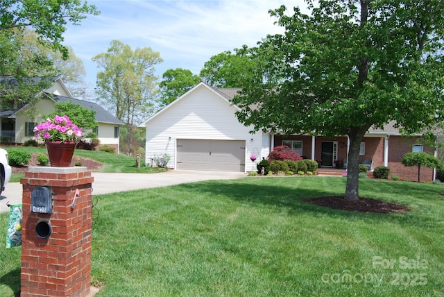 view of front of house with a garage, driveway, and a front yard