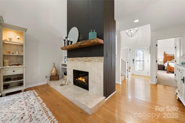 living room with light wood-type flooring and a premium fireplace