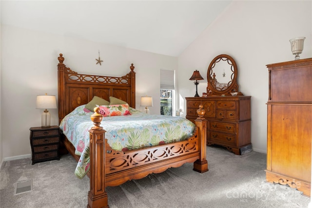 bedroom with light carpet and vaulted ceiling