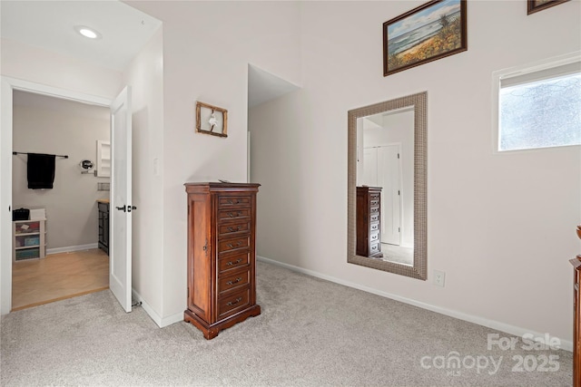 hall featuring light colored carpet