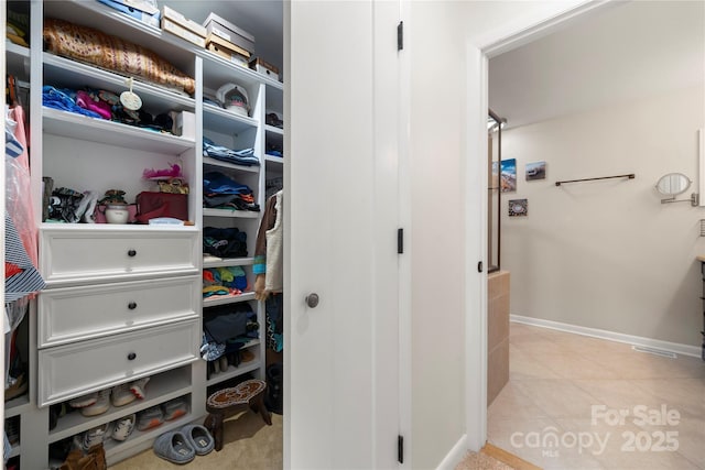 spacious closet featuring light tile patterned floors