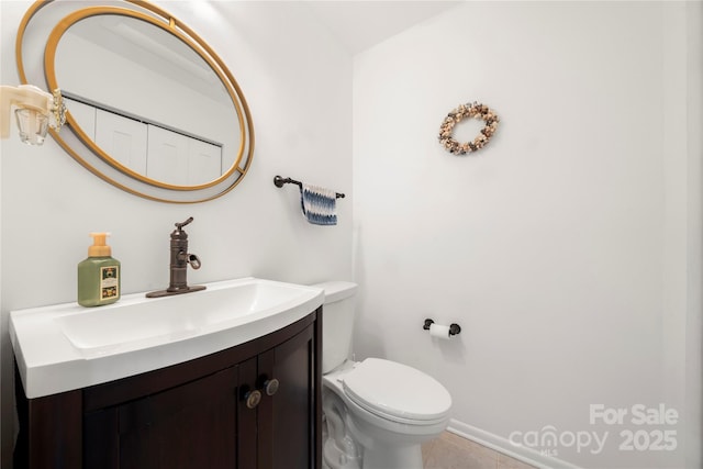 bathroom featuring toilet and vanity