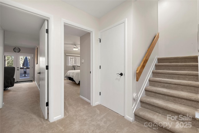 stairway featuring carpet and french doors