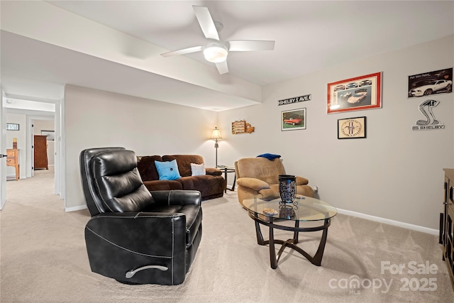 carpeted living room with ceiling fan