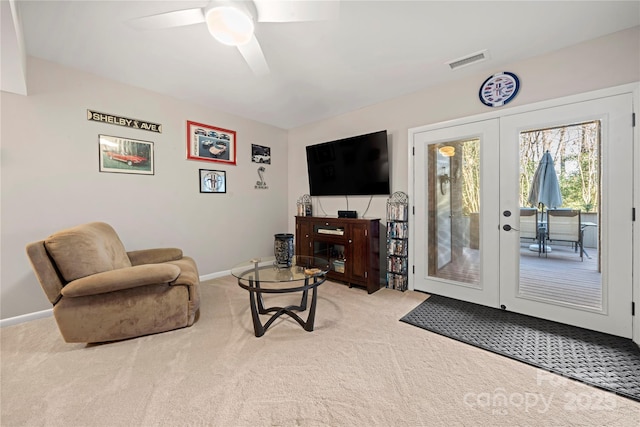 living room with ceiling fan, light colored carpet, and french doors