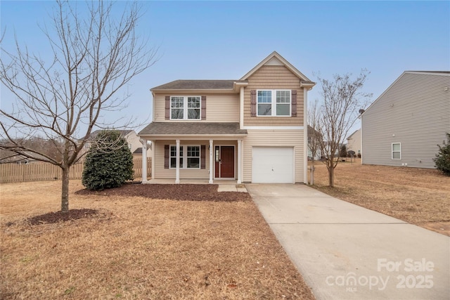 view of front of home with a garage, a front yard, and a porch