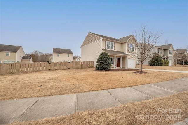 front facade featuring a garage and a front lawn