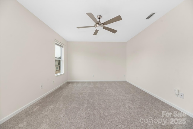 carpeted empty room featuring ceiling fan