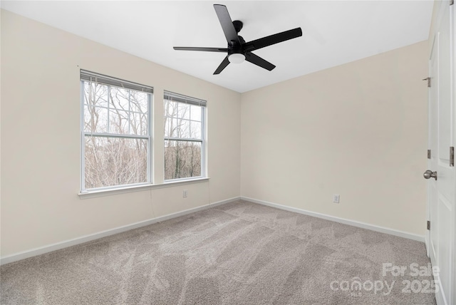 spare room featuring light colored carpet and ceiling fan