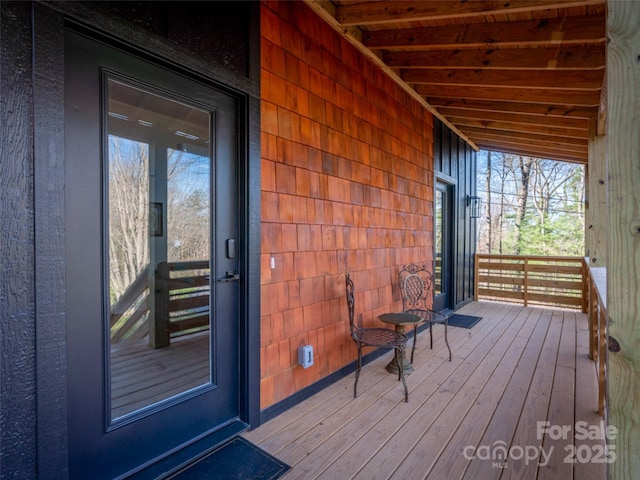 wooden terrace with a porch