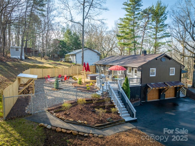 view of yard featuring a garage and a wooden deck