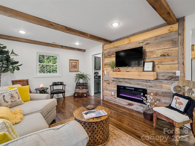 living room featuring hardwood / wood-style flooring, beam ceiling, and a fireplace