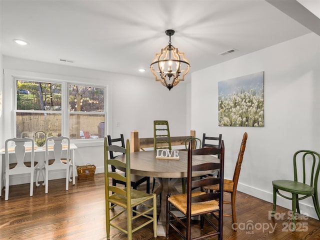 dining room featuring an inviting chandelier and dark hardwood / wood-style floors