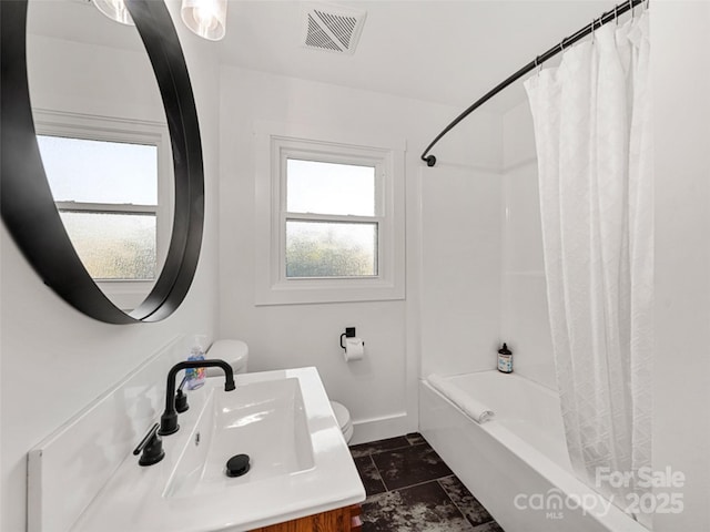 full bathroom with shower / bath combo with shower curtain, sink, toilet, and tile patterned flooring