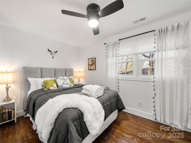 bedroom with ceiling fan and dark wood-type flooring