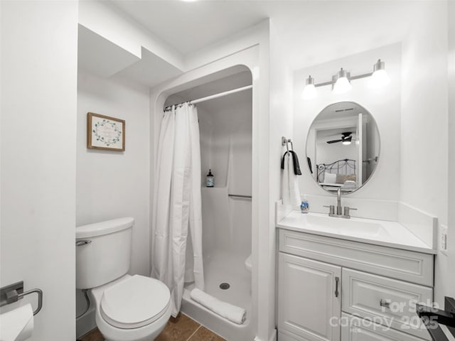 bathroom featuring toilet, vanity, tile patterned floors, and a shower with shower curtain