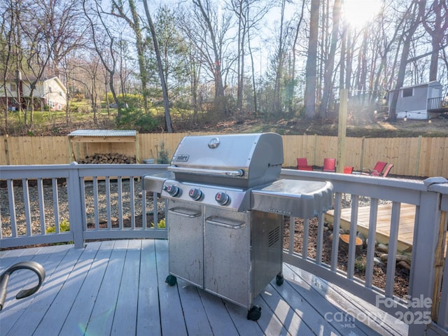 wooden terrace featuring area for grilling