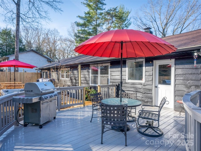 wooden deck with a grill