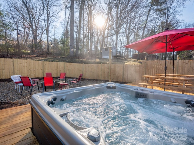 view of pool featuring a hot tub and a deck