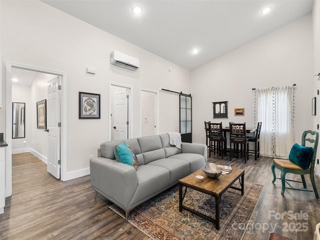 living room featuring dark hardwood / wood-style floors, a wall mounted AC, and a high ceiling