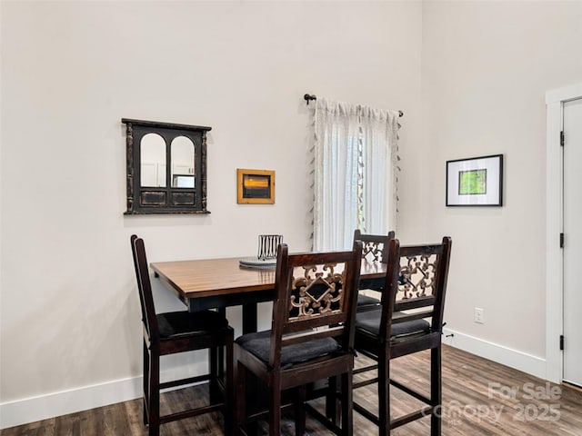 dining space featuring dark wood-type flooring