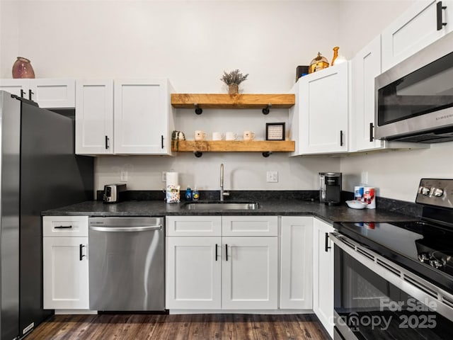 kitchen with sink, white cabinets, and appliances with stainless steel finishes